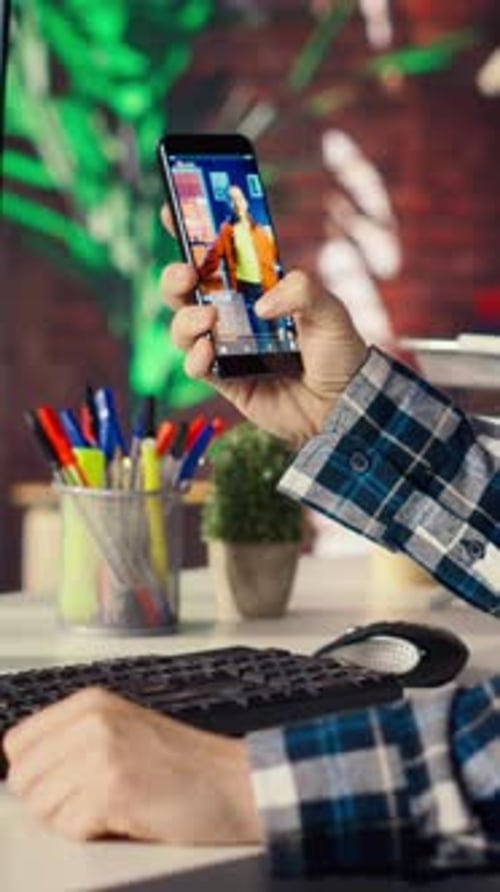 Video Call on Smartphone at Computer Desk