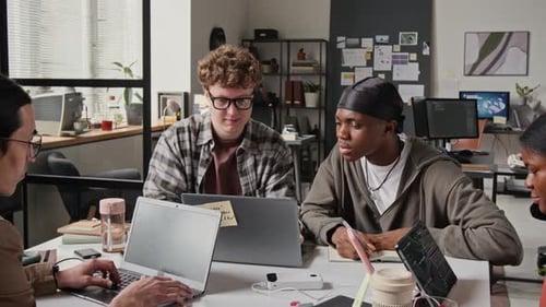 Multiethnic Male Programmers Fist Bumping during Collaborative Work