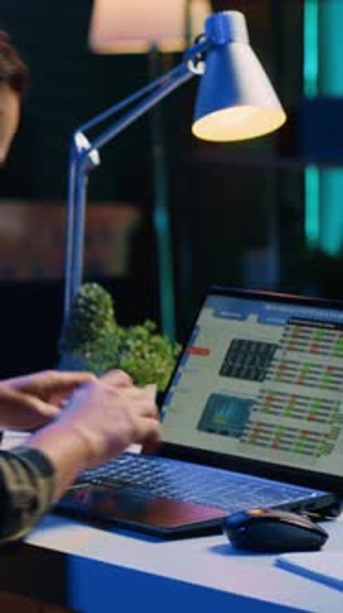 Man Works Late on Laptop in Dark Office