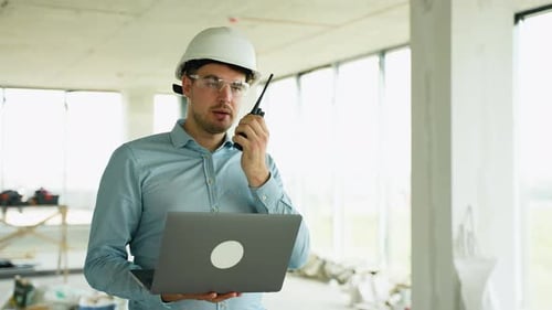 Civil Engineer Communicating with Team Via Radio