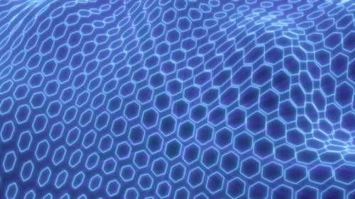 Rejilla de luz hexagonal azul futurista que forma un patrón de onda 3D dinámico, que simboliza la tecnología