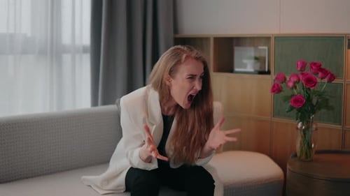 Distraught Woman Sitting on Couch in Room