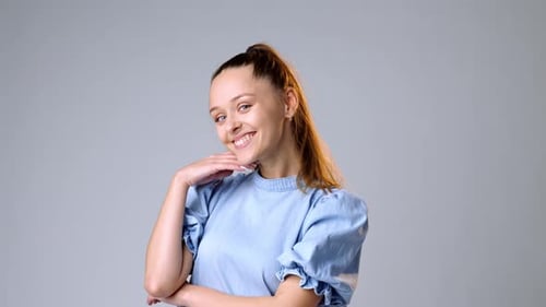 Smiling Woman Posing in Blue Dress in Studio
