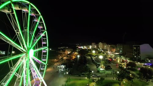 Night Aerial View of Lit Ferris Wheel and City