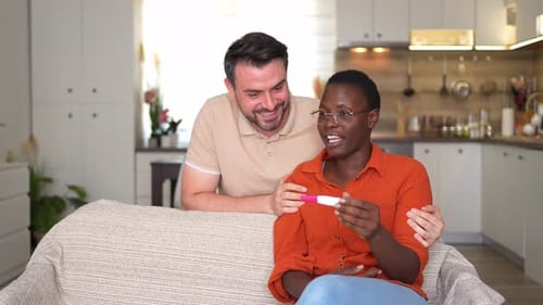 Happy Couple Excited Over Positive Pregnancy Test at Home
