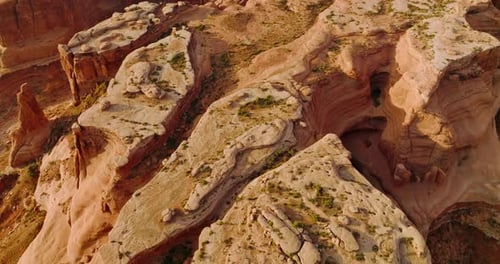 Amazing beautiful rocks formed by air erosion. Little green bushes growing on plain tops of mountain