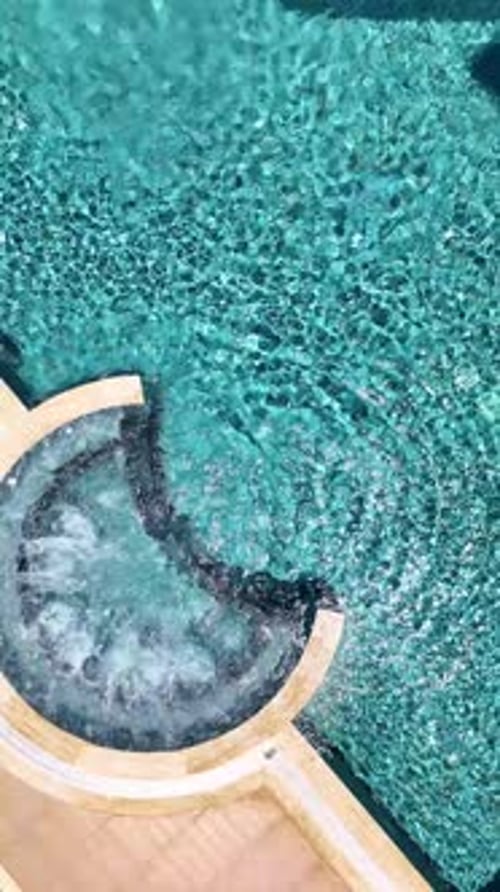 Vertical Video Aerial Serenity Views of a Jacuzzi Pool in an Elite Residential Complex