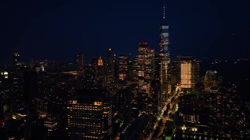 Vibrant New York with billions of lights. Drone footage descending above the night cityscape.