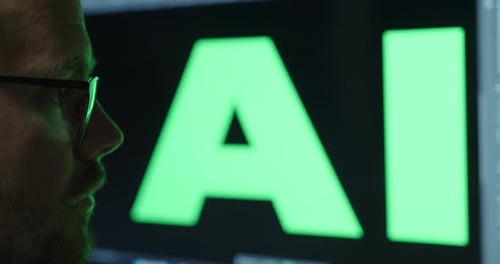 Close-up of a man looking amazed, with a large display behind him showing the word ‘AI’ prominently