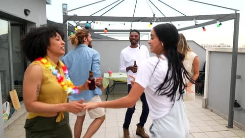 Friends Enjoying Rooftop Party Dancing and Having Fun