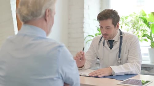 Doctor Discussing Medical Report with Old Patient