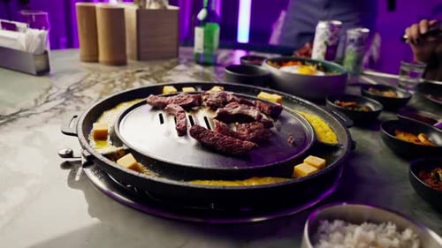 close up of delicious appetizing juicy piece of grilled meat with cheese being fried in korean