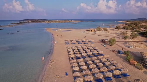 Aerial view of a sandy beach with umbrellas on a sunny day in summer