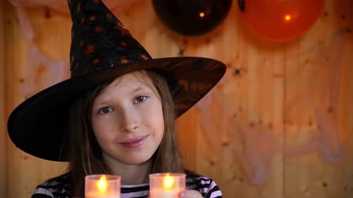 Smiling Child Celebrates Halloween with Candles
