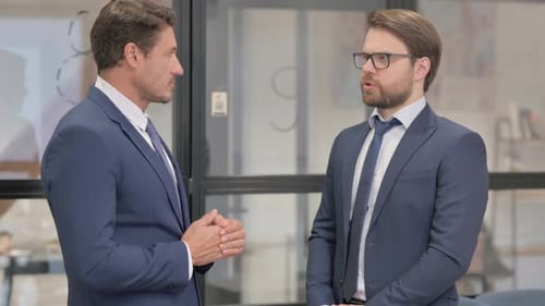 Angry Businessmen in Argument while Standing in Office