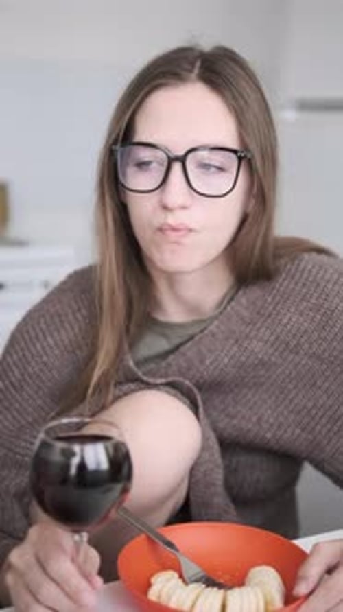 Woman Enjoying Red Wine and Banana at Home Kitchen Casual Meal Cozy Lifestyle