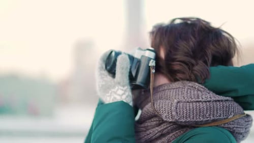 Woman Photographer Taking Pictures in Winter City