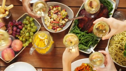Overhead shot of friends toasting drinks at table