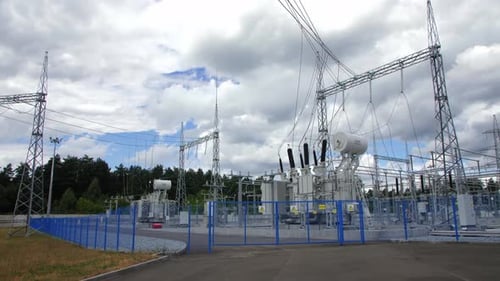 Electrical Distribution Substation Behind Blue Grid Fence