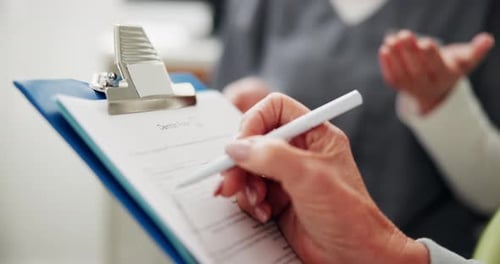 Woman Filling Out Dental Form in Clinic