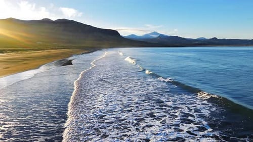 Cinematic Sunrise Over Black Sand Volcanic Beach with Crashing Waves Serene and Tranquil Landscape