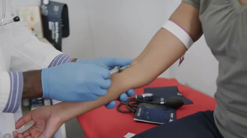 Medical Professional Giving Injection to Patient in Office