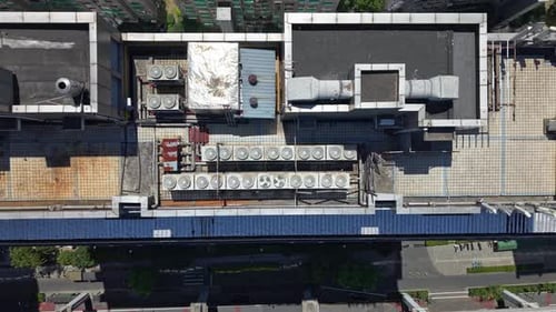 Aerial View of Multiple Cooling Units Situated on a Rooftop The System Features a Series of Large