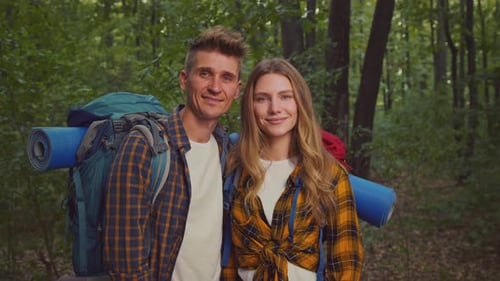 Couple Enjoys Outdoor Adventure While Camping and Hiking in a Lush Forest