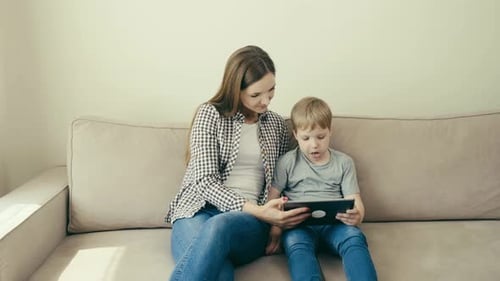 Mother and Child Together Using a Tablet at Home