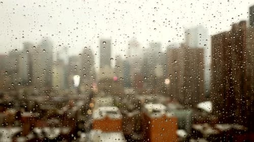 Rain Drops on Window Obscuring City Skyline