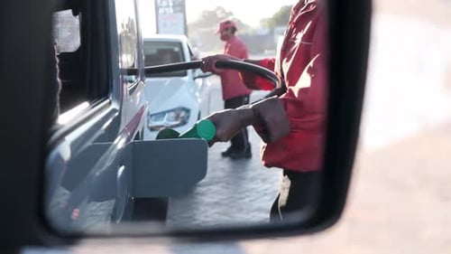 Putting fuel into a car petrol attendant