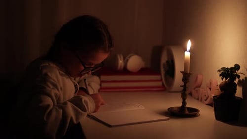 Girl Writing in Notebook by Candlelight
