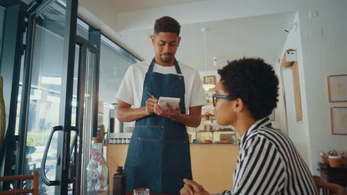 Cinematic image of waiters employees working in a nordic styled cafe