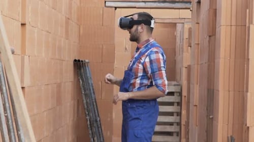 Construction worker uses VR headset on building site