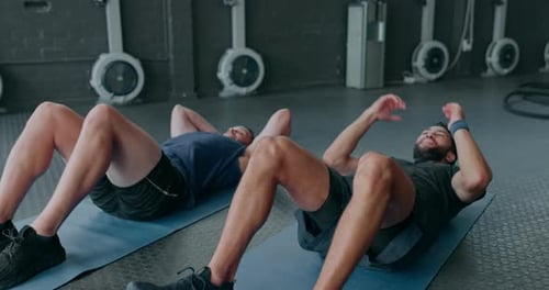 Two Men Doing Crunches in a Gym