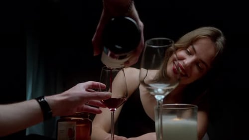 A Man is Pouring a Glass of Red Wine For a Woman - Close Up