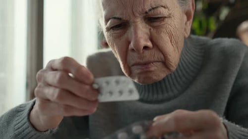 Senior Woman Taking Pills From Blister Pack