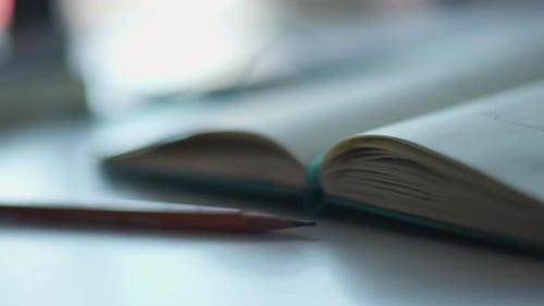 Open notebook with pencil on a desk