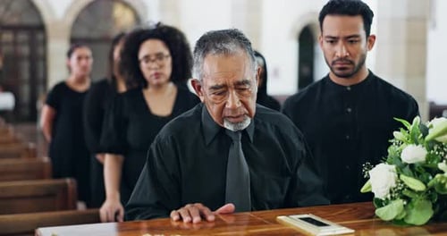 Funeral, coffin and sad man at church for death and grief with people at burial ceremony