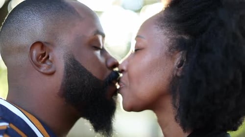 Loving Couple Sharing Intimate Kiss in Sunny Nature