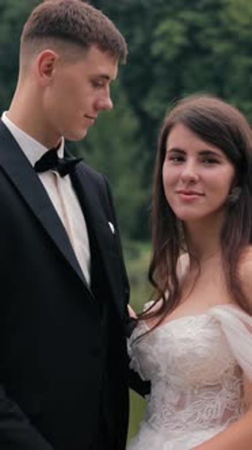 Romantic Couple Posing By Serene Lake Surrounded By Lush Green Nature Bride and Groom Holding Hands