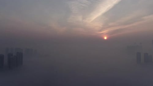 A city that seems to be floating in the air with fog and dust.