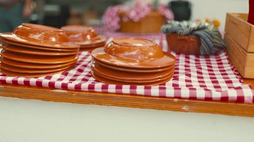 Plates on a Checkered Tablecloth at a Market in the