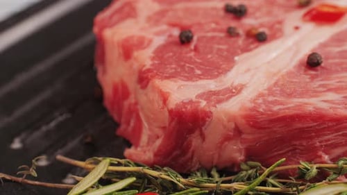 Juicy Raw Steak with Herbs and Peppercorns