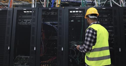 Technician working on servers in data center