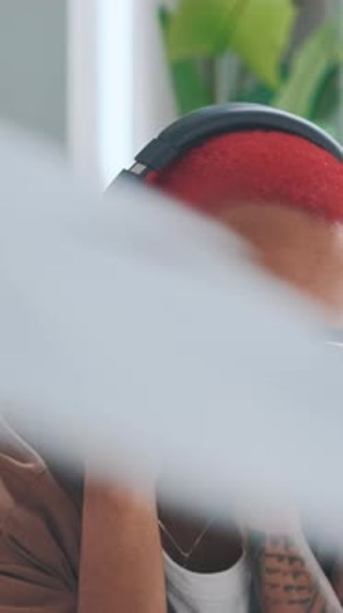 Hip Young Adult Listening to Music on Headphones