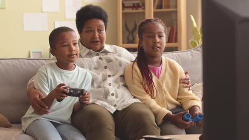 Family Gaming Together on Couch Indoors