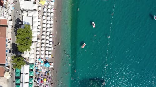 Aerial View of Beach with Swimmers and Umbrellas
