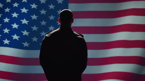 Man Salutes American Flag in Dark Clothing