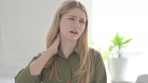 Woman Rubbing Her Neck in Discomfort